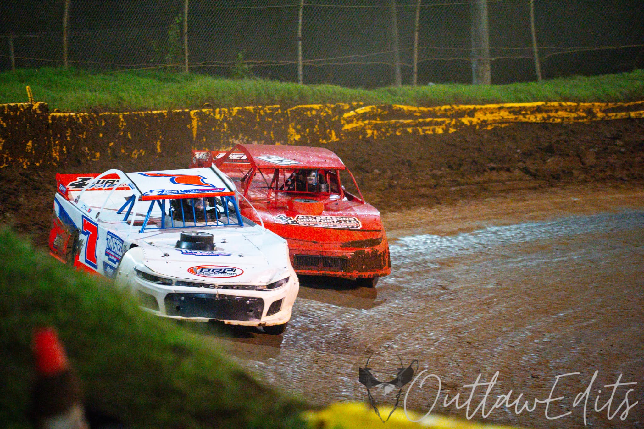 Street stock race cars competing on a dirt track
